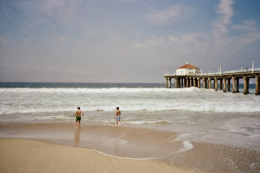Two children at the edge of the surf